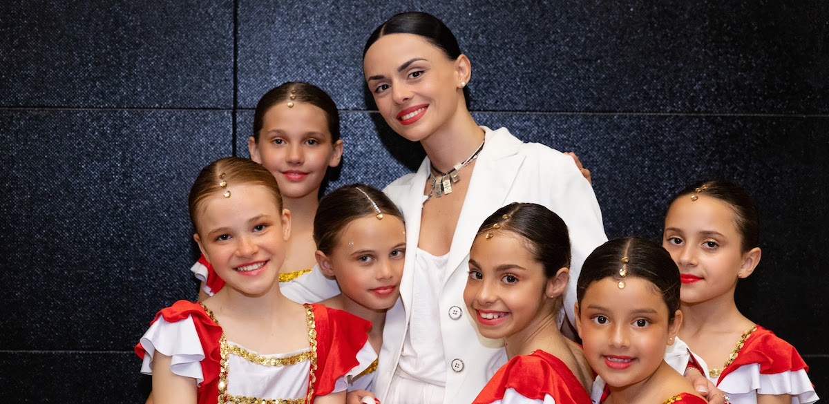 Dance teacher posing with her students